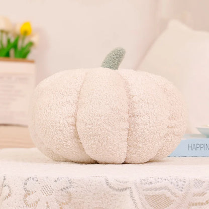 White pumpkin-shaped pillow on a surface with a blurred background
