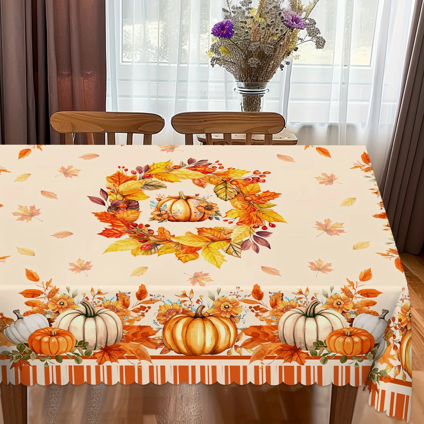 Tablecloth with autumn design featuring pumpkins and leaves on a dining table.