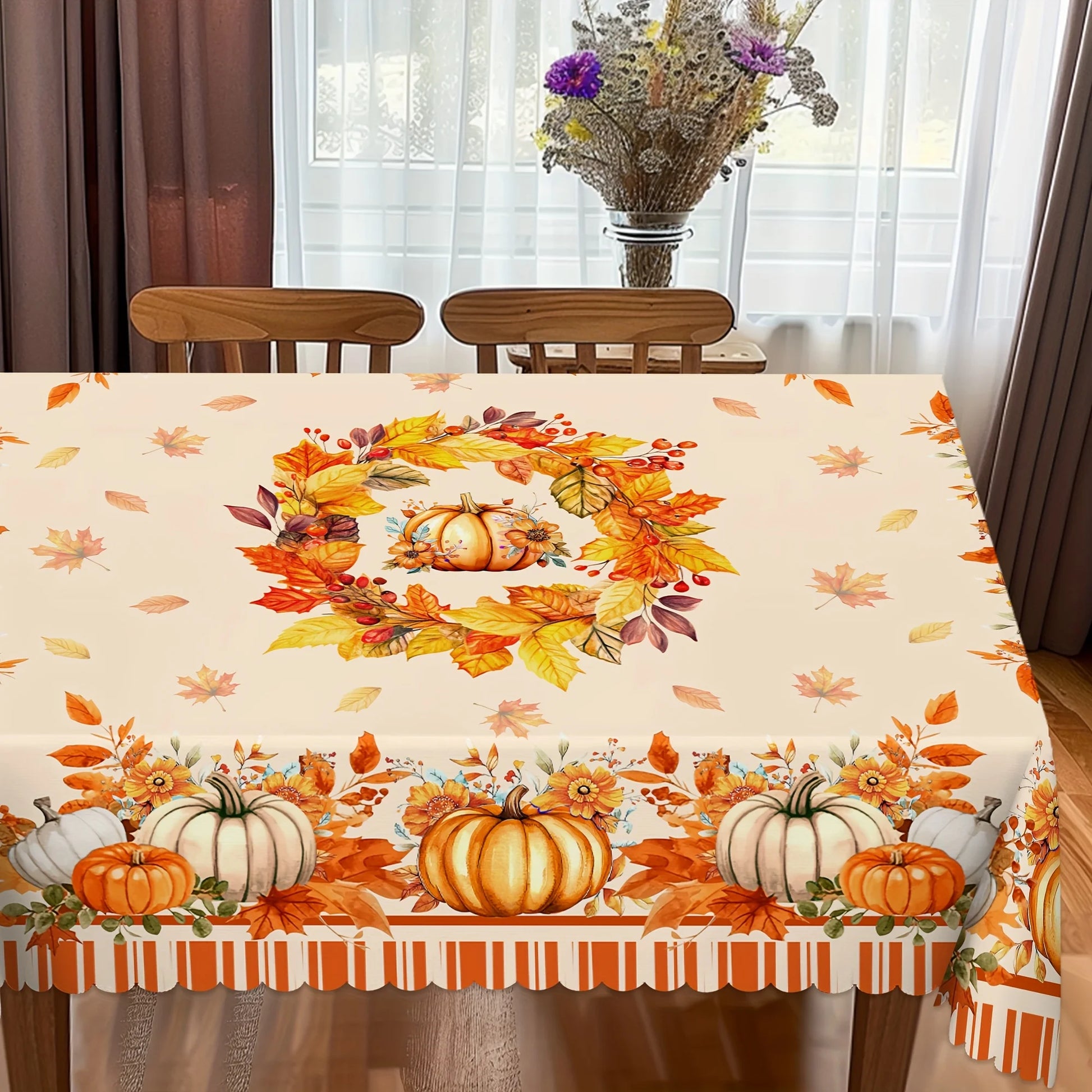 Tablecloth with autumn design featuring pumpkins and leaves on a dining table.