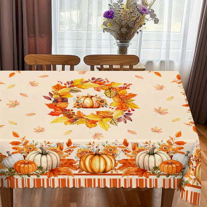 Tablecloth with autumn design featuring pumpkins and leaves on a dining table.