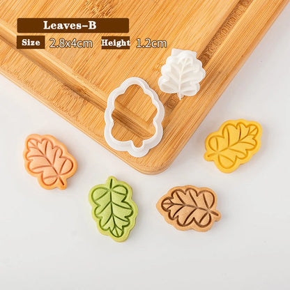 Leaf-shaped cookie cutters on a wooden board with measurements displayed.