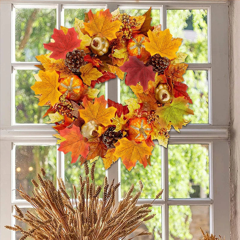 Autumn wreath with colorful leaves and pinecones on a window background