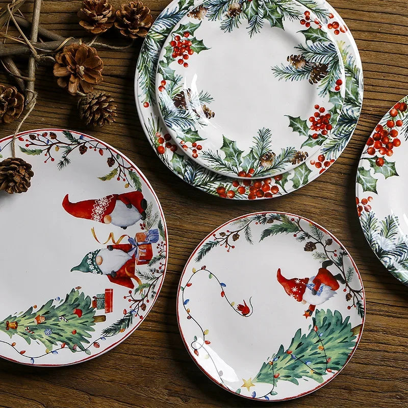 Set of Christmas-themed ceramic plates with decorative patterns on a wooden surface.