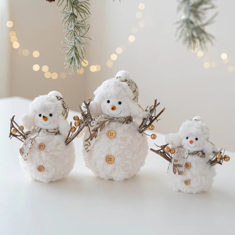 Three decorative snowmen with buttons and branches on a light background with blurred lights and greenery.