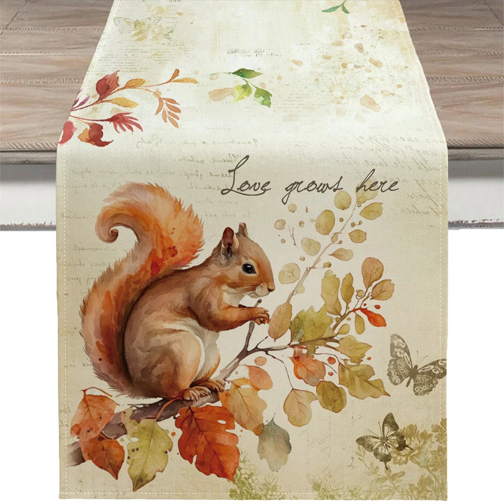 Decorative table runner with a squirrel and autumn leaves design on a wooden surface.