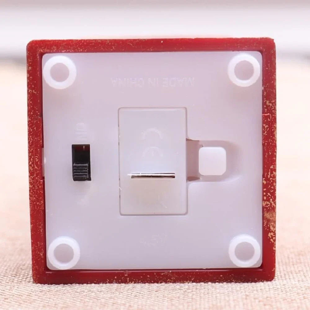 Light switch with red frame on a beige background