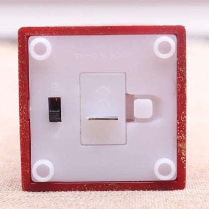 Light switch with red frame on a beige background