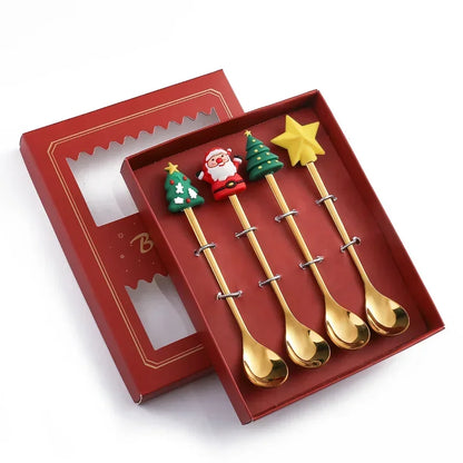 Set of four gold Christmas-themed spoons in a red box