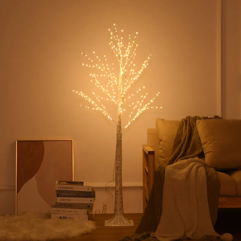 Decorative light tree in a room with a couch and books