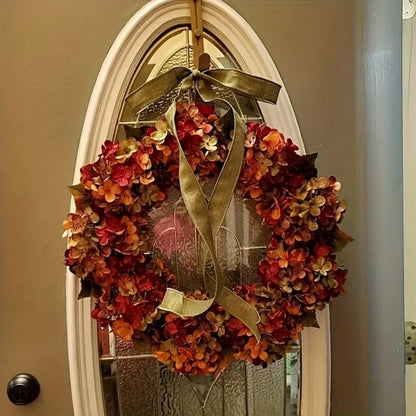 Autumn wreath with a gold bow on a door