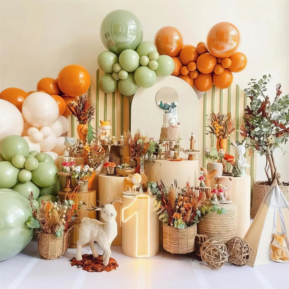 Decorative setup with balloons, plants, and a cake for a celebration.
