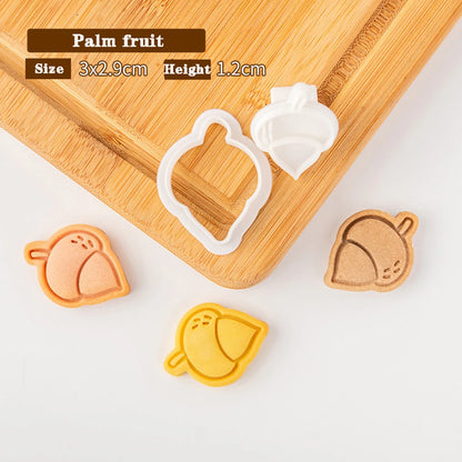 Palm fruit cookie cutters on a wooden board with measurements displayed.