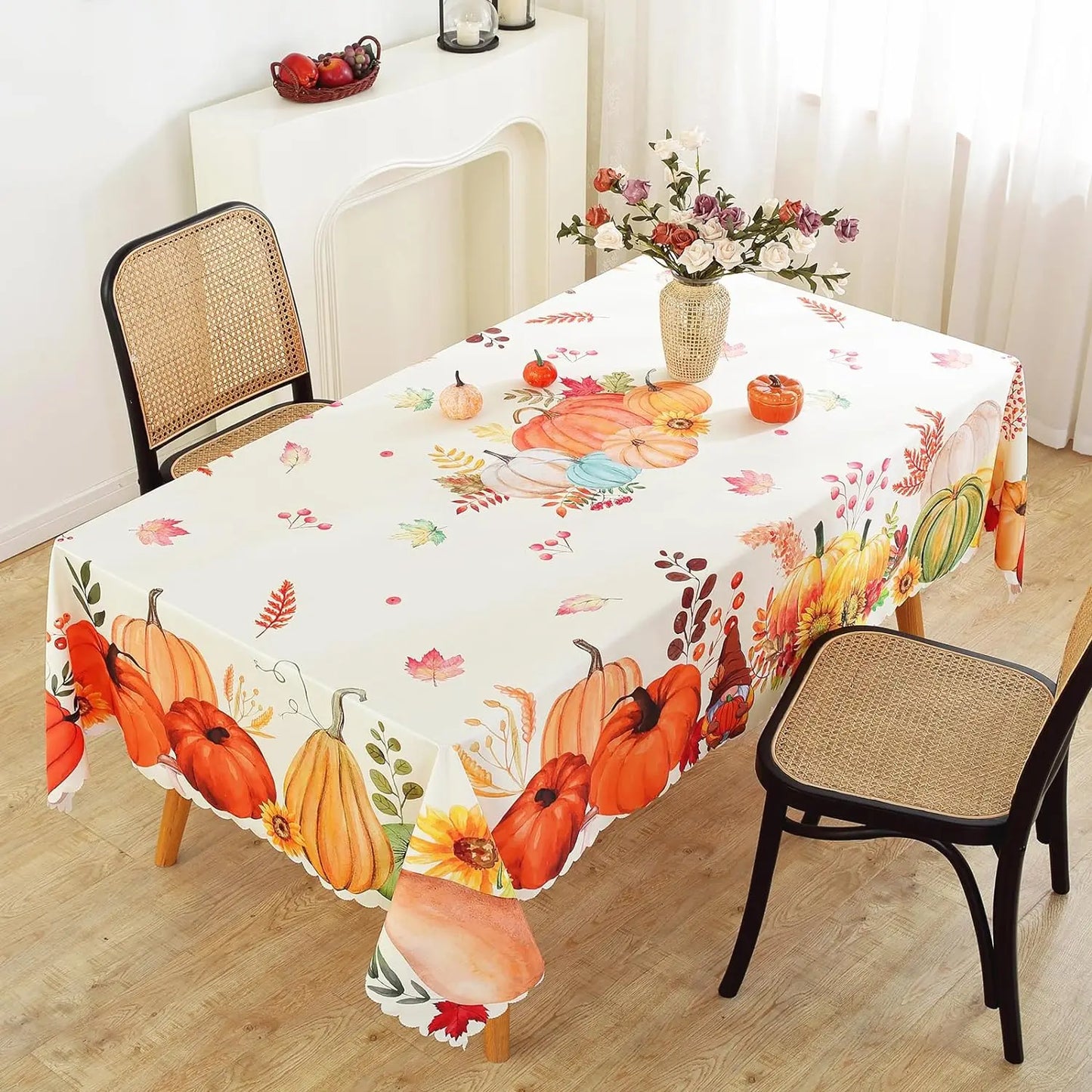 Tablecloth with autumn design featuring pumpkins and leaves on a dining table.