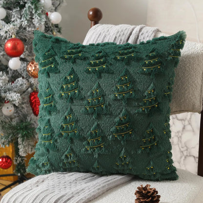 Green textured pillow on a couch with a Christmas tree in the background