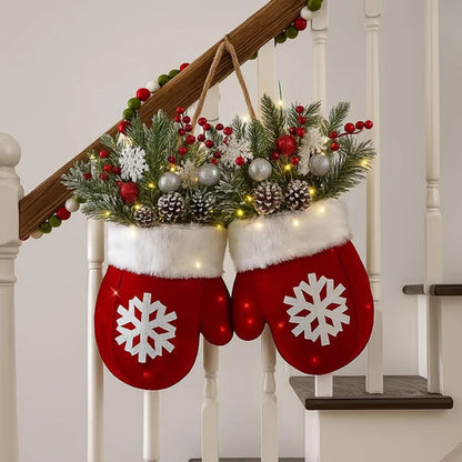 Red mitten-shaped stockings with snowflake designs hanging on a staircase decorated with greenery and lights.