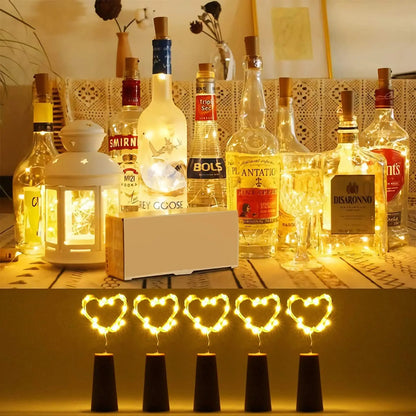 Alcohol bottles with decorative lights on a table, including Smirnoff and Bols brands.
