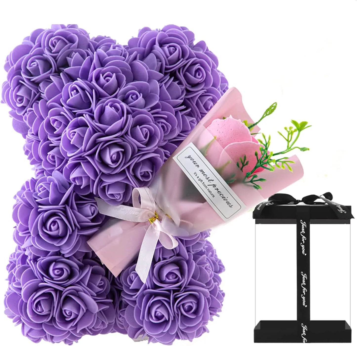 Purple rose teddy bear with a small bouquet of pink roses on a white background