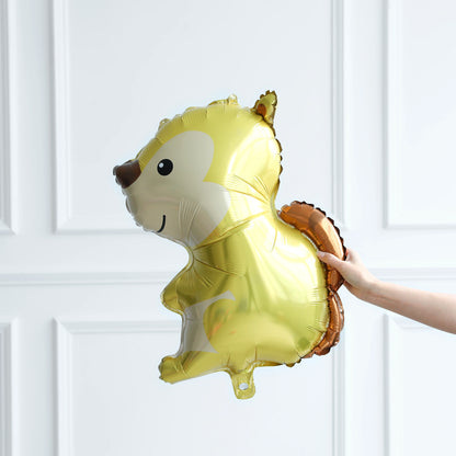 Gold squirrel-shaped balloon held against a white paneled wall