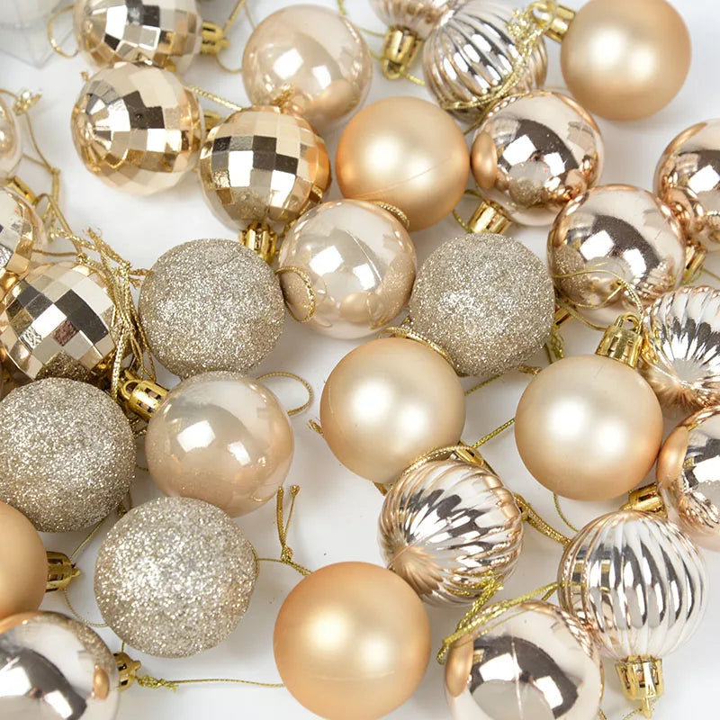 String of gold, silver, and rose gold Christmas ornaments on a white background