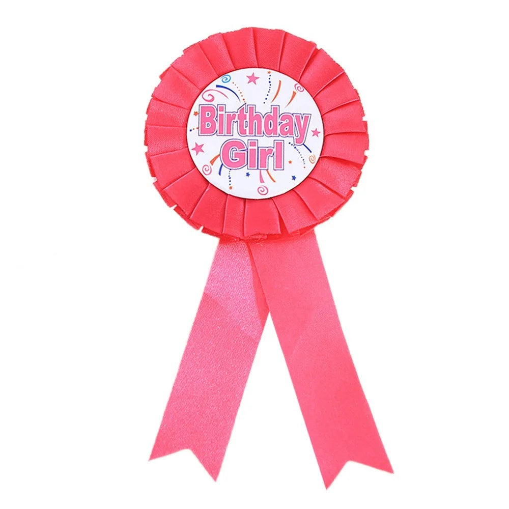 Pink ribbon with 'Birthday Girl' badge on a white background