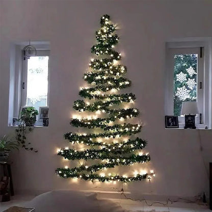 Wall-mounted Christmas tree with lights in a room with windows and plants.