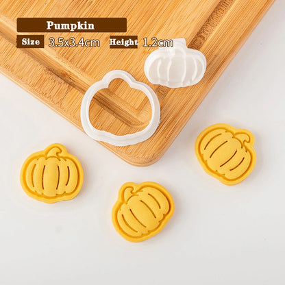 Pumpkin-shaped cookie cutters on a wooden board with measurements displayed.