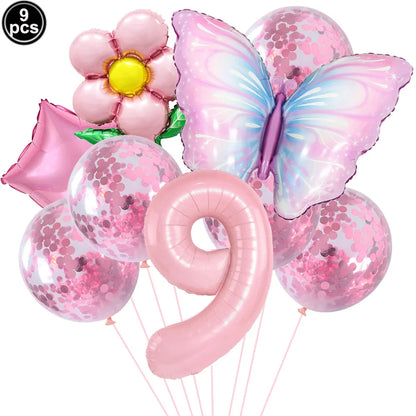 Set of pink balloons including a butterfly, flower, and number 9 on a white background