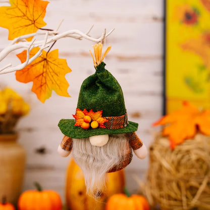 Decorative gnome with autumn-themed hat among pumpkins and leaves