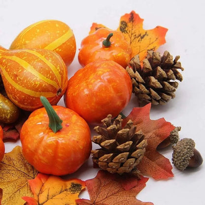Autumn-themed arrangement with pumpkins, gourds, pinecones, and leaves on a white background