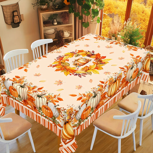 Dining table with a decorative tablecloth featuring pumpkins and leaves, surrounded by chairs.