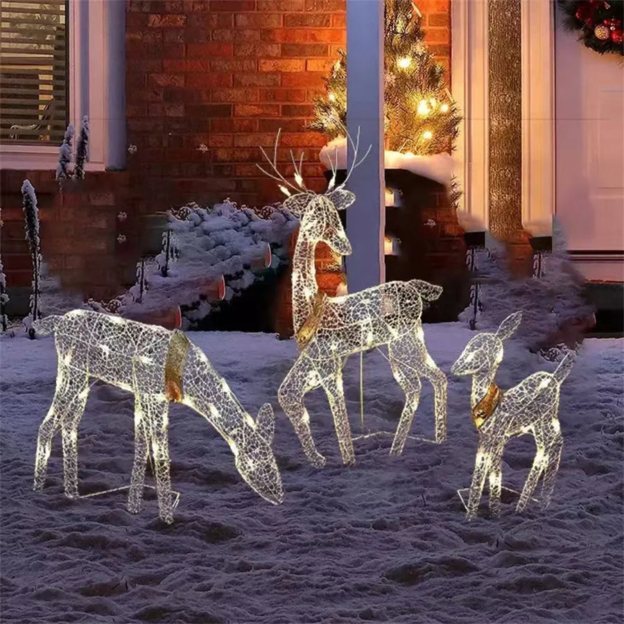 Decorative LED reindeer set on a snowy ground with a festive background.