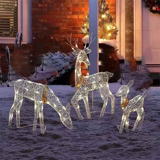 Decorative LED reindeer set on a snowy ground with a festive background.