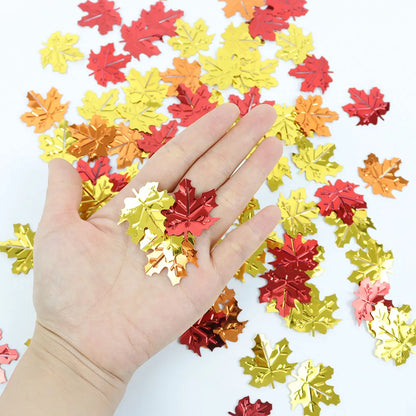 Colorful leaf-shaped confetti scattered on a white background with a hand holding some leaves.