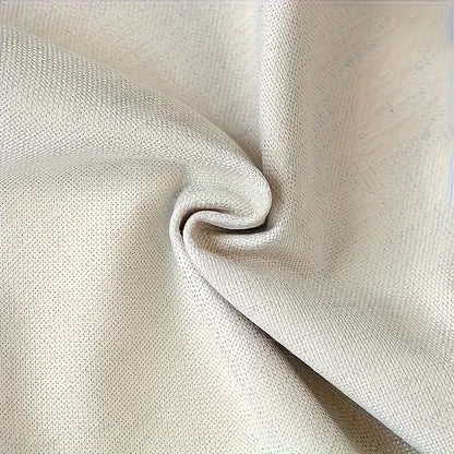 Close-up of beige fabric with a slight texture