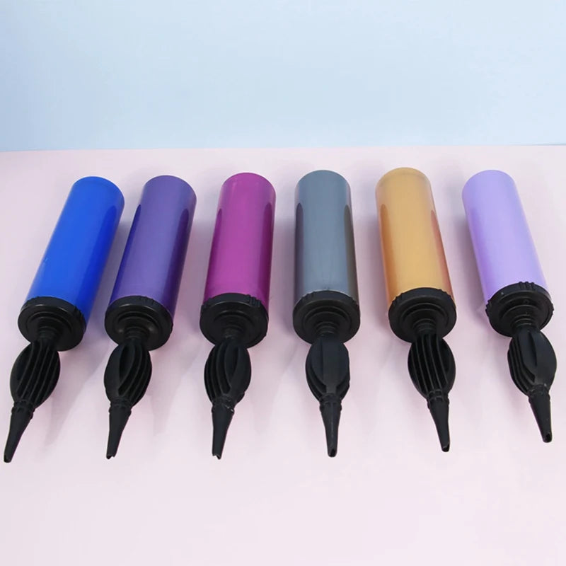 Set of six balloon inflators with different colored bodies on a light pink background