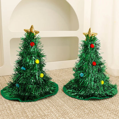 Two small green Christmas trees with decorative stars and balls on a beige carpet.