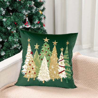 Decorative pillow with Christmas tree design on a couch next to a decorated tree.