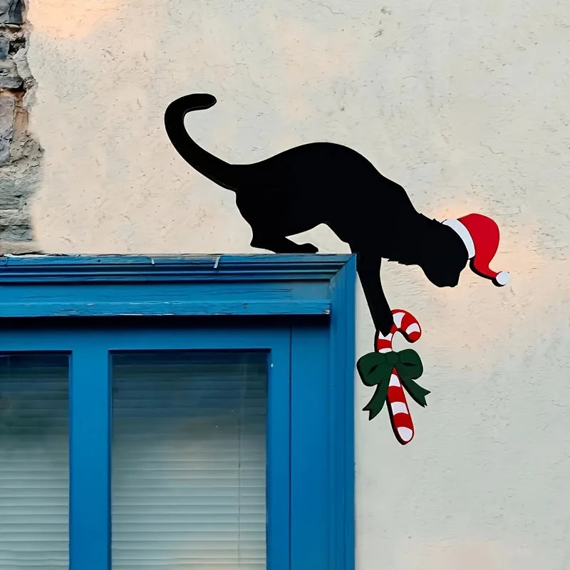 Black cat silhouette with a Santa hat and candy cane on a textured wall.