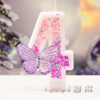 Decorative candle shaped like the number 4 with a butterfly and pink glitter on a blurred background