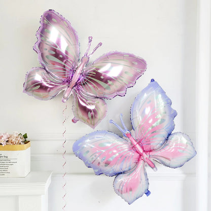 Two butterfly-shaped balloons in pink and purple on a white background