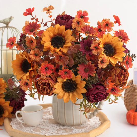 Autumn-themed floral arrangement with sunflowers and pumpkins on a decorative table.
