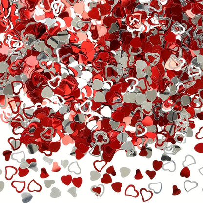 Red and silver heart-shaped confetti on a white background