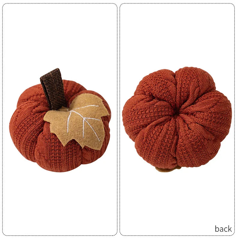 Two knitted pumpkins with a leaf on a white background