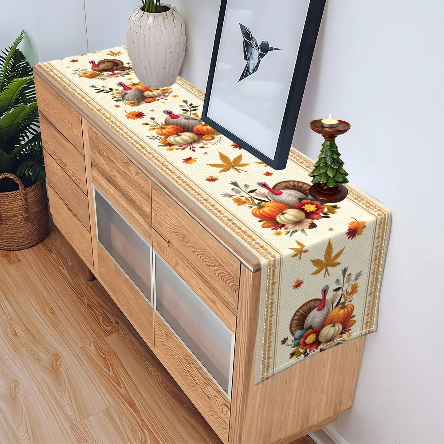 Decorative table runner with autumn theme on a wooden console table.