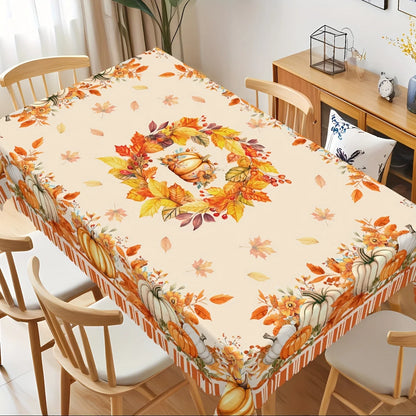 Tablecloth with autumn design featuring pumpkins and leaves on a dining table.