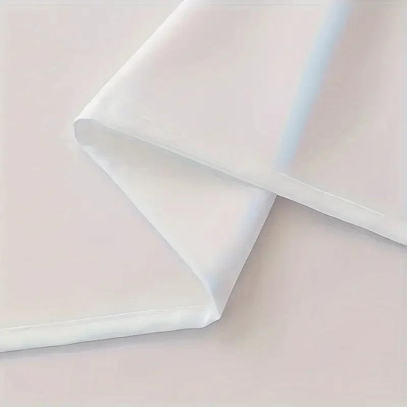 Folded fabric with a soft pink and white gradient on a light pink background