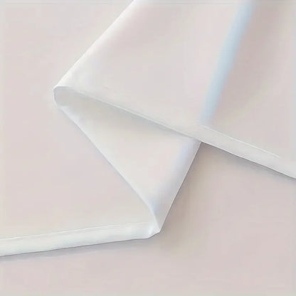 Folded fabric with a soft pink and white gradient on a light pink background
