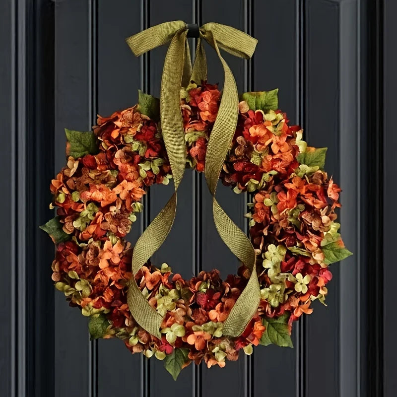 Decorative wreath with autumn colors and a green ribbon on a black door.