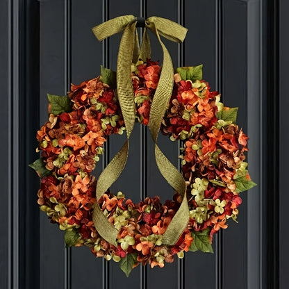 Decorative wreath with autumn colors and a green ribbon on a black door.