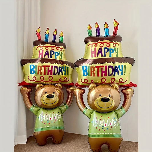 Two bear-shaped birthday balloons with cake toppers and candles on a plain background